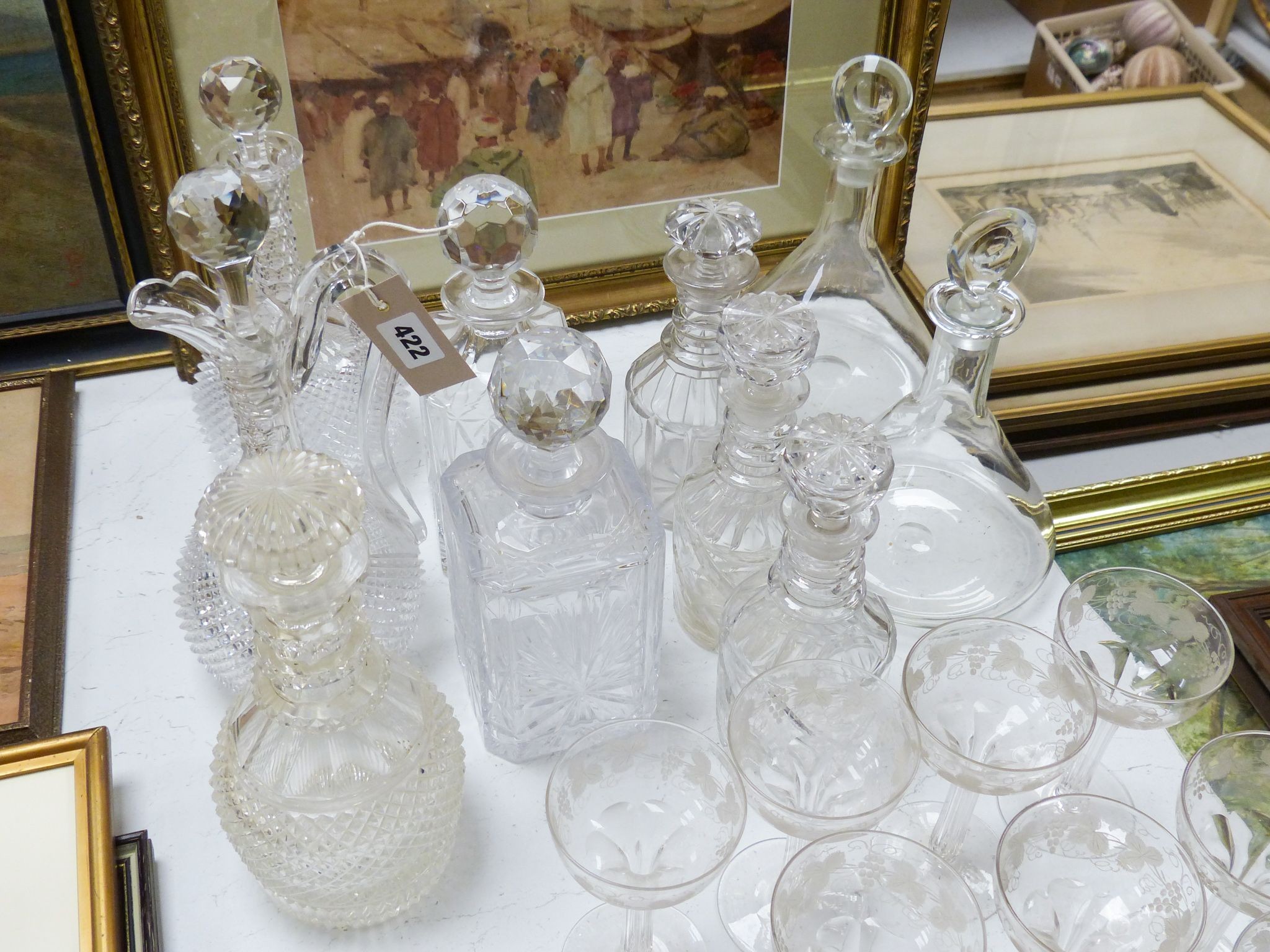 A Victorian diamond cut claret jug and decanter, assorted other decanters and champagne flutes